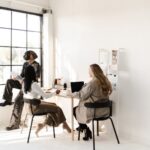 3 women sitting for a group coaching session